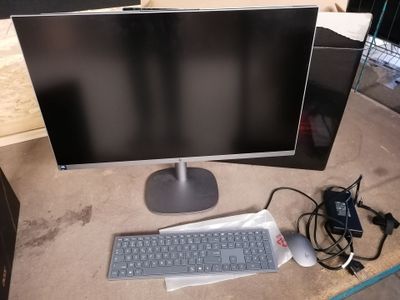 a computer monitor and keyboard sitting on a desk
