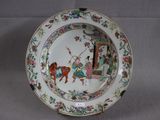 a plate with a picture of a man riding a horse on it
