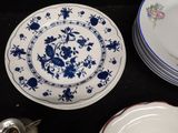 many plates that are sitting on a black table