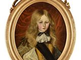 portrait d'un jeune garçon dans un cadre doré, vêtu d'un manteau noir et blanc