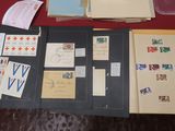 a table with a lot of papers and stamps on it