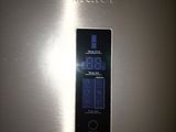 a stainless steel refrigerator with a digital display on the door