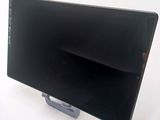 a black computer monitor sitting on top of a white table