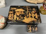 a black and gold box sitting on a table next to other items