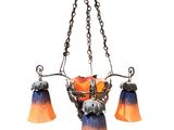an orange and blue chandelier hanging from a chain