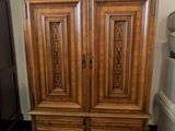 a large wooden armoire in the corner of a room