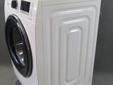 an image of a washing machine on wheels on a grey surface