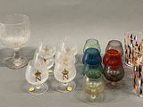 a lot of different glassware on the table