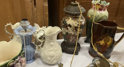many different vases on a table with a white table cloth