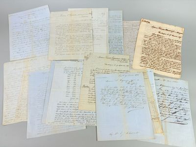 several old papers are stacked on top of each other on a table