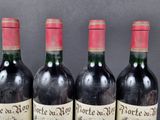 four bottles of wine are lined up on a table