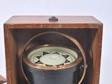 a small wooden box with a clock inside of it