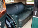 a black leather couch sitting in the back of a car
