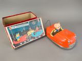 an orange toy car and a box with a pig on it