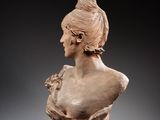 a close up of a bust of a woman on a gray surface