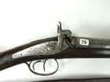 two old guns are on display on a shelf in a room