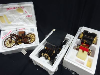 two boxes that have a small model of a car inside of them