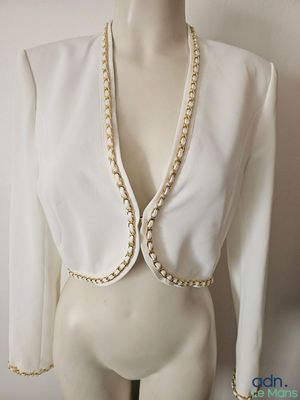 an image of a mannequin wearing a white top with pearls on it