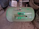 a green tank that is sitting on the ground
