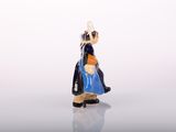 a small figurine of a woman with a blue dress