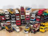 a lot of toy buses that are sitting on the floor