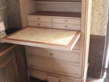 a cabinet with a drawer on top of it in a room