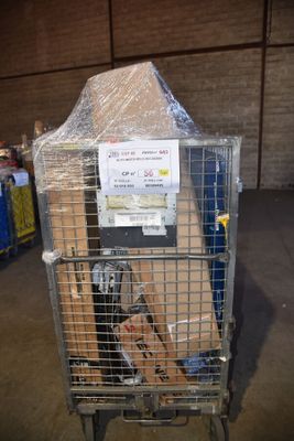 a cart full of boxes in a warehouse with a sign on it