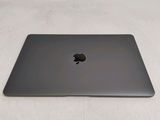 an apple macbook pro laptop sitting on top of a white surface