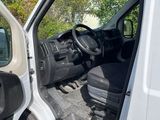a white van with the door open and the driver ' s seat down