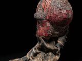 an image of a sculpture of a woman ' s head with a scarf around it