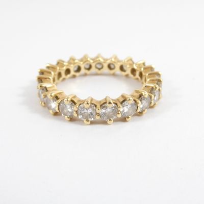 an image of a yellow gold ring with white diamonds