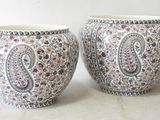 two vases sitting next to each other on a table