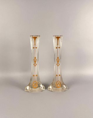 pair of clear glass vases with gold designs on the sides