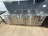 a stainless steel counter top with a bunch of drawers on it