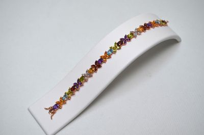 a close up of a white plate with a colorful bracelet on it