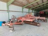 a tractor and a plow in a building