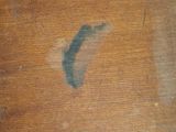 a close up of a wooden table with a stain of paint on it