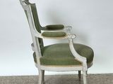 an image of a chair with a green upholstered seat in a room