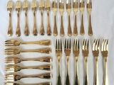 a set of twelve gold plated forks and spoons