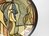 a plate with a picture of a woman on it
