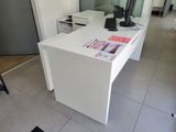 a white desk with a computer on it in a room
