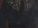 portrait of a man in a black coat and a gold scarf