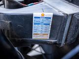 a close up of a car ' s engine with a sticker on it