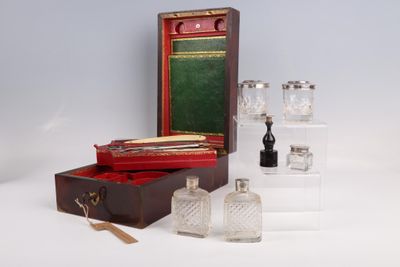 three bottles and a box of glass on a table