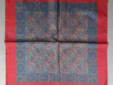 a close up of a red and blue paisley pocket square