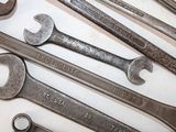 a lot of wrenches that are laying on a table