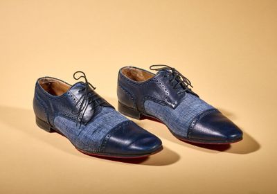 two pairs of men ' s shoes on a yellow background