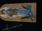 a picture of an angel on a skateboard on a black surface
