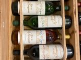 many bottles of wine in a wooden box on the counter
