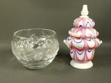 a small vase and a small glass on a table